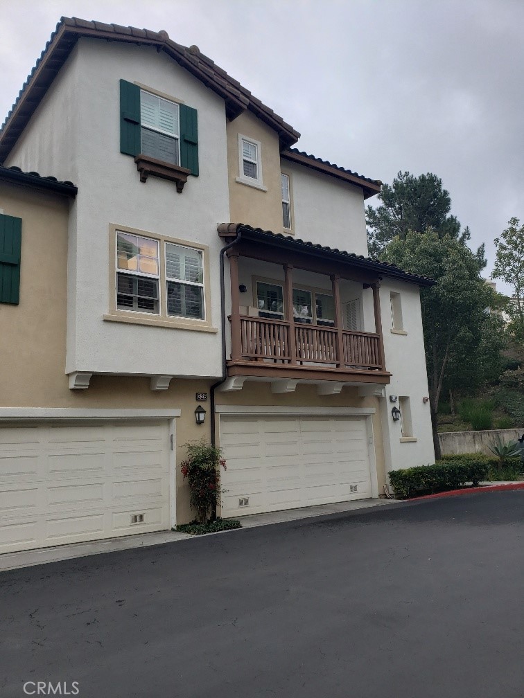 This 3-story quiet end/corner unit condo. Private entry. Living room with fireplace and media niche. Plantation wood shutters all over. Master suite on 3rd floor. Both bedrooms have ceiling lights installed. Kitchen with pantry and breakfast bar, open to airy balcony. Hardwood flooring at living/dining/kitchen areas and tile floors at all bathrooms. Two-door refrigerator, newer stacked washer/dryer included. Attached 2-car full sized parallel parking garage with storage area and new installed EV charger. House to be professionally cleaned and carpet shampooed.