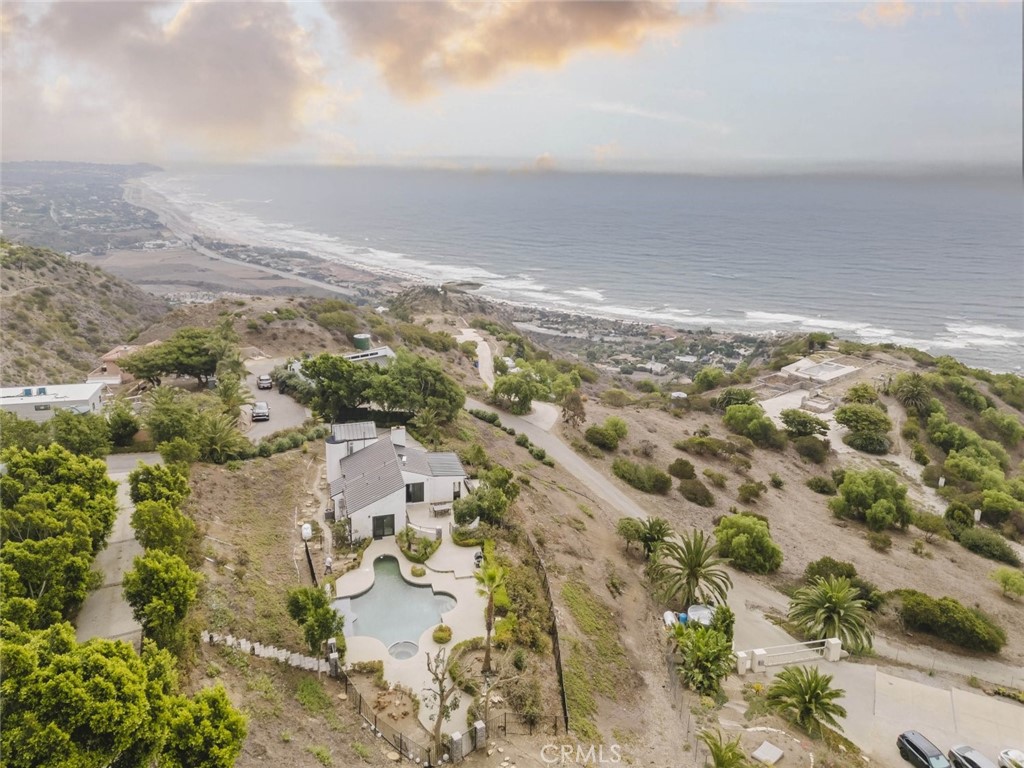 Experience the essence of Malibu luxury at 31518 Anacapa View Drive Unit A, a breathtaking single-family residence where modern elegance meets coastal tranquility. This exquisite 3-bedroom, 1-bath home spans 1,209 sq. ft. and offers sweeping mountain and ocean views that capture the very best of California living.
The interior exudes sophistication with its modern design elements and a stunning living room featuring a beautifully crafted stone fireplace. Expansive black sliding doors open to an inviting outdoor oasis, creating a seamless flow between indoor comfort and open-air relaxation. The main bathroom is a true retreat, boasting a soaking stone tub and a designer-tiled shower that embody spa-like serenity.
Outdoors, you'll find an entertainer's paradise with a sparkling pool, rejuvenating hot tub, and a stylish patio complete with comfortable furnishings and a picnic-style dining area, perfect for gatherings under the Malibu sky. With two uncovered parking spaces and every detail thoughtfully curated, this home offers a lifestyle defined by luxury, comfort, and the natural beauty that makes Malibu world-renowned.