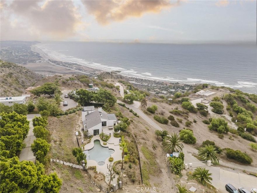 Experience the essence of Malibu luxury at 31518 Anacapa View Drive Unit A, a breathtaking single-family residence where modern elegance meets coastal tranquility. This exquisite 3-bedroom, 1-bath home spans 1,209 sq. ft. and offers sweeping mountain and ocean views that capture the very best of California living.



The interior exudes sophistication with its modern design elements and a stunning living room featuring a beautifully crafted stone fireplace. Expansive black sliding doors open to an inviting outdoor oasis, creating a seamless flow between indoor comfort and open-air relaxation. The main bathroom is a true retreat, boasting a soaking stone tub and a designer-tiled shower that embody spa-like serenity.



Outdoors, you'll find an entertainer's paradise with a sparkling pool, rejuvenating hot tub, and a stylish patio complete with comfortable furnishings and a picnic-style dining area, perfect for gatherings under the Malibu sky. With two uncovered parking spaces and every detail thoughtfully curated, this home offers a lifestyle defined by luxury, comfort, and the natural beauty that makes Malibu world-renowned.