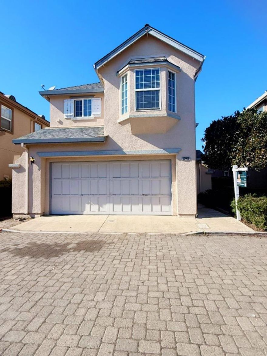 Welcome to this well maintained two-story residence featuring 3 bedrooms, 2.5  bathrooms, perfectly designed for comfort and modern living. Step inside and be greeted by a bright, vaulted-ceiling living room with tile flooring in the living room and dining room area. The kitchen and down stairs bathroom has newly installed vinyl linoleum flooring. The specious kitchen features tile countertops, a glass-tile backsplash, a kitchen bar - the perfect spot to enjoy breakfast or chat with love ones and stainless steel appliances that blend style and function beautifully. A half bathroom is located downstairs, making entertaining easy and effortless. Upstairs, you'll find three comfortable bedrooms and two full bathrooms, including a serene primary bedroom offering peace and privacy. Step outside to an easy to maintained backyard, beautifully finished with brickwork throughout, ideal for family gatherings, barbecues, or simply relaxing in your own private space.