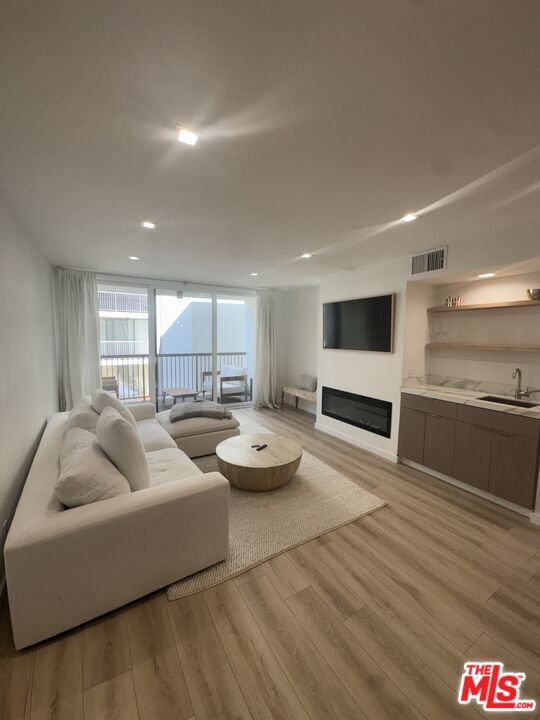 One-of-a-Kind 1 bedroom for lease! This beautifully updated unit offers metropolitan style living in the heart of West Hollywood. This gorgeous 1 bedroom / 1 bathroom condo is ideally located on a tree lined street in West Hollywood near the best of everything. Located on the second floor, the unit features a covered private balcony, an open layout with large living room with fireplace and ample kitchen area, a spacious bedroom that includes a walk in closet and east facing window, a beautifully appointed bathroom with a quartz vanity top, floating vanity cabinets, beautifully designed shower with rain shower head that completes the layout, while additional closets provide extra storage. The floor-to-ceiling glass wall and sliders open to a private balcony overlooking the courtyard and pool. Enjoy cooking in an updated kitchen with quartz counters and stylish cabinets, and entertaining in the adjacent dining area. Recess lighting thoughout with central AC and heat. Building amenities offered are a pool, fitness center, one assigned parking space in the gated garage, and controlled security access. This desirable location between Santa Monica Blvd. and Melrose Ave. near Kings Road Park is convenient to some of LA's favorite shopping, restaurants, nightlife, and services (Erewhon and Gelsons). Situated south-facing, on the desirable Kings Road, this light-filled unit offers both privacy and charm. Includes one parking space, cable, wifi, water, trash, and HOA fees. Unit can be delivered totally furnished!