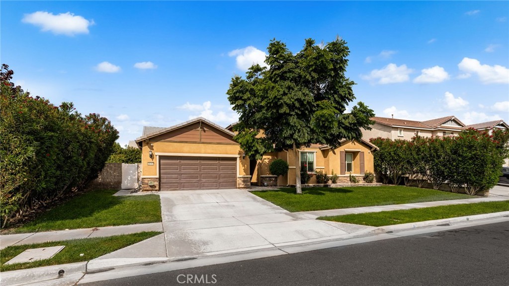 This gorgeous single-story residence in the desirable Serrano Ranch neighborhood in Jurupa Valley is Now Available! It boasts an open floor concept, with approximately five bedrooms with walk-in closets and four full bathrooms. As you enter into the home you will be welcomed into the long foyer front entrance with a trayed ceiling, leading into the large gathering room with a lighted built-in AV unit. Large windows look out to the backyard and covered patio. A flex room to the right can serve as your formal dining room or beautiful sitting area. Enjoy your chef-inspired kitchen with a built-in microwave/oven combo and a separate oven and gas cooktop. All cabinets feature drawers for easy access, including the large island, all with "Bianco Antico" granite countertops and a walk-in pantry. Enjoy the planning center near the kitchen with a built-in desk with drawers. This unique multi-functional space gives you a place to manage your busy life and stay organized; a family office, craft storage, or a spot for the children to do homework. Unwind in the spacious Owner's Suite located in the back of the residence for privacy featuring a huge bathroom suite, walk-in shower with seat, dual sinks, and a large walk-in closet. The other side of the residence includes an additional private full suite with a walk-in closet and full bathroom that could be used as a granny in-law suite. There are 3 additional bedrooms with walk-in closets and windows along with 2 additional full bathrooms. Porcelain and ceramic flooring throughout with 5" baseboards. Enjoy the beautifully manicured backyard garden with Japanese Privit, Crepe Myrtle, Lemon, Lime, Orange, Tangerine, and Apricot trees, all producing fruit! This extraordinary residence is across from the Serrano Ranch neighborhood park, a small park with walking path, tot lot, basketball court and a baseball diamond.