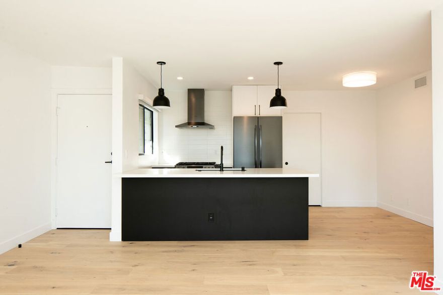 Beautifully renovated 2 bed, 3 bath in the coveted Ocean Park neighborhood of Santa Monica. This west-facing unit perfectly embodies modern coastal living, blending bold black & white finishes with elegant natural woods to create a stylish, inviting aesthetic. The kitchen is equipped with soft-closing custom cabinetry, black stainless steel Bosch appliances, quartz counters, breakfast bar & walk-in pantry, and opens to the living area w/ balcony & peek-a-boo ocean views. Generously sized bedrooms have en-suite bathrooms and closets with customizable Elfa systems. The unit is complete with central A/C w/Nest thermostat, recessed lighting, engineered light oak hardwood floors, and in-unit laundry. The building features an expansive community rooftop deck with breathtaking panoramic ocean views. Located just minutes to Main St, Rose Ave, the beach & Abbot Kinney.