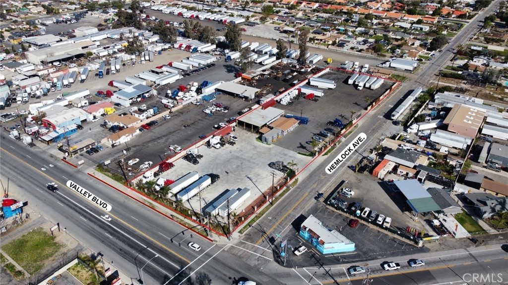 Allied Commercial is pleased to present an exceptional turnkey opportunity for users seeking an ideal location for truck parking, repair, sales, and or outdoor parking requirements. This 2.2 +/- Acre parcel boasts fully fenced, paved grounds with suitable drainage accompanied by an approximately 4,000 +/- SF overhang canopy clearing for truck service which includes power throughout. Adjacent you will find two contiguous office buildings at approximately 900 +/- SF. Positioned with 175 linear feet of frontage on Valley Blvd, the location ensures prime visibility and accessibility through Hemlock Ave with two entrance/exit points. The location features prime access just off the 1-10 Freeway between cherry Ave and Citrus Ave enabling seamless transportation logistics.