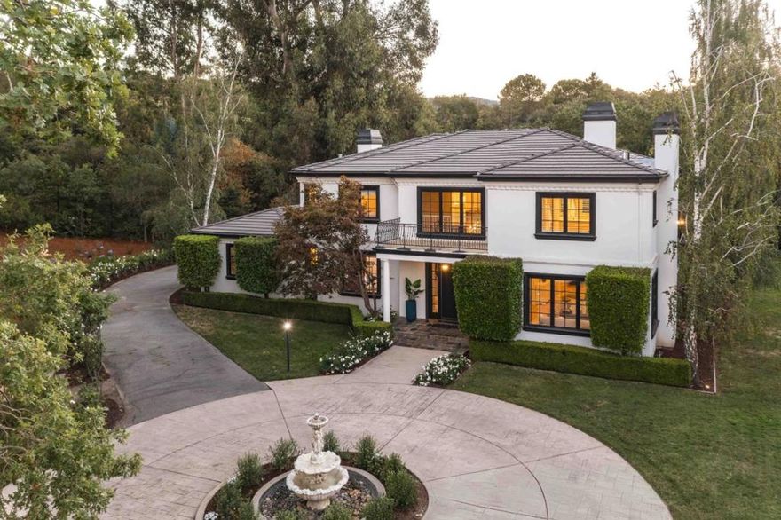 Tucked away at the end of a cul-de-sac, this refined home sits on more than an acre of gated grounds and offers over 4,900 square feet of light-filled living space. A circular driveway with a central fountain sets an elegant tone, leading into a residence defined by timeless style - rich hardwood floors, detailed millwork, soaring ceilings, and expansive formal rooms ideal for entertaining. The home also boasts a handsome study, an inviting eat-in kitchen, and multiple fireplaces throughout. Five spacious bedrooms include a private guest suite and a luxurious primary suite with its own fireplace, spa-like bath, and balcony overlooking the backyard, which offers excellent space to entertain with a vast patio, pool, spa, and sweeping lawn. Comfort and convenience are enhanced by air conditioning and a 4-car garage with dual Tesla EV chargers. Enjoy quintessential Atherton living close to Stanford, downtown amenities, and acclaimed Las Lomitas schools (buyer to verify eligibility).