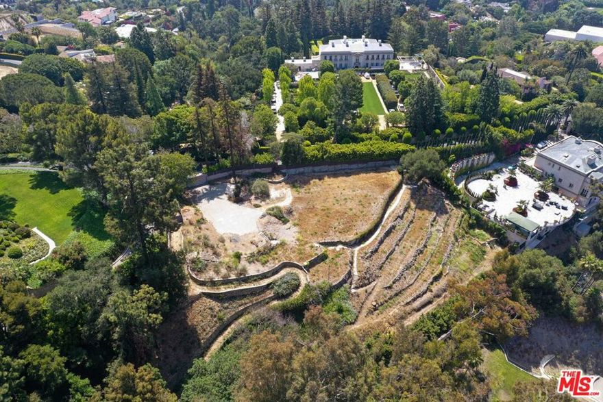 Rare opportunity to develop a 21,000-SF estate on a magnificent 1.4-acre lot with sweeping views from Bel-Air to the Pacific Ocean. Designed by SAOTA, a world-renowned architecture firm based out of South Africa. An organic modern architectural marvel that is fully immersed in its picturesque surrounding. Captivating open floor design with an elegant flow and glass sliding windows throughout fills every corner of the home with natural light and the most undisrupted views. 3-story mega-mansion offering the most stunning indoor-outdoor barrierless lifestyle and entertaining features. Its great room, formal dining room, breakfast and den with soaring ceilings open to a sprawling, verdant terrace with zero-edge pool spilling to the LA skyline. Multiple outdoor entertaining areas including lounge terraces and rooftop lounge. World-class amenities include a tennis court and gym. For car aficionados, an oversized subterranean garage, and a show garage. Pajamas lounge with a garden provides a perfect retreat. Leave your mark on one of the most prestigious streets in Bel-Air.