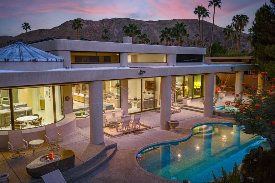 One of the ONLY true architectural, custom homes in Indian Canyons. A step above the rest. There are grand proportions throughout this 3,687 sq ft 4 bedroom/5 bath home. The view and orientation are perfect. With a fabulous pedigree, designed by Holden & Johnson Architects and built by Stoker Construction in 1993. Plate glass and steel reinforcements were used throughout to create expanses which soar across large open volumes with exceptional, uninterrupted views. Other custom design features include textured wall treatments, tongue and groove ceilings with unique details, monumental solid slab fireplace, and a dramatic wet bar which delivers front row seats to an unobstructed view of Mt. San Jacinto. The layout is ideal. The entertaining areas and the master suite all are on the pool side with sliders and good indoor/outdoor flow. The leisure area features several patio areas, a lagoon style pool surfaced with blue tile, a separate spa, as well as a fire feature area and an outdoor barbecue. The house sits on the 13th fairway of the Indian Canyons north golf course, and yet is entirely private and shielded from view thanks to a hedge of ficus along the perimeter. Solar is owned. 3 car garage is attached. No HOA. Short term rentals are allowed (currently the neighborhood is below the city-regulated quota). Land lease runs through 2063 and is $5,996 per year. Offered furnished with artwork excluded, per seller inventory.