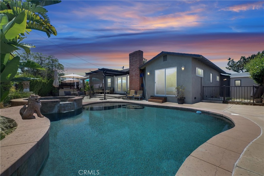 This is definitely NOT your typical OC interior tract, cul de sac, cookie cutter North Tustin Pool home. Romanza Place has BIG personality starting with a brand NEW contemporary front door. The stamp-stained concrete driveway has been expanded and enlarged. The drought tolerant front yard has artificial turf installed and automatic sprinklers to keep the tangerine, lime tree, and shrubs happy. The ceilings throughout this Home are a smooth texture, no acoustic ceilings, and most lights in the Home are on dimmers. The original wood floors remain under the carpet. Central Air was added and a NEW Furnace. The windows have been replaced in recent years with Milgard dual pane vinyl windows and sliding glass doors to let in the light. There are Ceiling fans in several locations, and an inside Laundry with a pantry. The Living room showcases French doors overlooking the pool that boasts a Pebble-tec finish and a wood burning Fireplace to give a warm, cozy feeling to the Living Room. The Dining room can easily seat a party of 6. The Kitchen feels larger than most built in the day, with lots of cabinets, gas cooktop, double oven, recessed lights, and NEW tile floor. Unique to this Home is the front Bedroom that has its own keyed entrance where you’ll find a richly colored room with a deceptively large mirrored slider closet with additional storage above, and an adjoining ¾ Bath with a NEW Vanity, New toilet, and a NEW ceramic tile floor. The Pool/Spa area is perfect for your Labor Day gathering with a built-in BBQ and a low maintenance aluminum Patio Cover. Or maybe you like hanging out in the Garage, which has been completely renovated with the installation of drywall on all walls, NEW paint, and a NEW drywall ceiling with canned Lighting. There’s even a NEW garage door and a NEW garage door opener. And did I mention this home falls into the coveted Tustin Unified which features the highly sought after Foothill High?