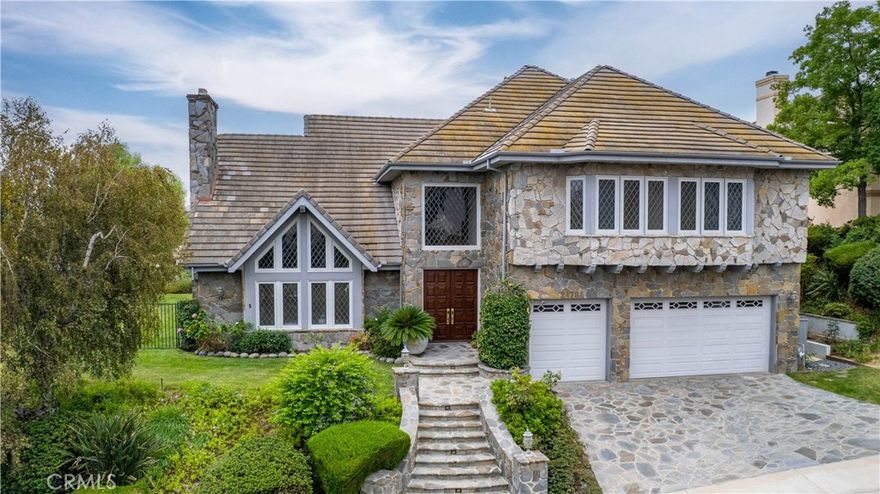 A rare opportunity to own a remarkable 4,500+ sq. ft. traditional Zuckermann VIEW home in the prestigious Valley Circle Estates. Impeccably maintained and ideally positioned at the foot of the Victory Trailhead, this residence makes a lasting impression from the moment you arrive. A grand foyer welcomes you with soaring, beamed ceilings, a sweeping oak staircase, and diamond-grid windows that exude timeless elegance.



Inside, discover four recently renovated bathrooms and newly installed hardwood floors that flow seamlessly throughout. The expansive living room, anchored by a dramatic fireplace, connects to a formal dining room designed for hosting gatherings of every size.



The chef’s kitchen is a dream for those who love to cook and entertain, featuring dual Viking ovens, a six-burner Viking range, Sub-Zero refrigerator/freezer, an expansive island, and abundant cabinetry, combining practicality with enduring style.



The lower level enhances the home’s livability with a spacious family room and built-in bar, a private in-law suite with full bath, a dedicated laundry room with sink, and an additional powder room for guests.



Upstairs, the luxurious primary suite offers panoramic valley views, a private balcony, cozy fireplace, and a sun-drenched spa bath with freestanding tub, dual vanities, and a cedar-lined walk-in closet. Two additional bedrooms and a well-appointed bathroom complete the upper level.



Step outside to your private paradise. A perfect balance of hardscape and lush lawn, a sparkling pool, built-in BBQ, and sweeping 180° views, ideal for entertaining or unwinding in the California sun.



Blending timeless design with modern comforts, this estate is a legacy waiting to be lived.