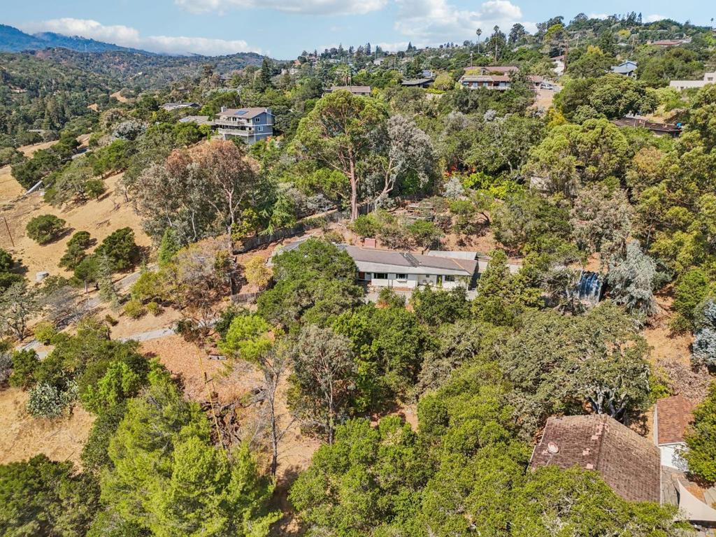 Nestled in the hills of Redwood City, 1780 Edgewood Road offers inspiring views and abundant opportunity on an expansive lot. This unique residence features tile and hardwood floors throughout, a spacious kitchen with exceptional layout, and a primary bedroom with an ensuite bathroom of generous proportions and direct access to a private outdoor area perfect for a transformation into a secluded garden retreat. The hillside setting provides both privacy and mountain vistas, while the lot itself offers ample room for future enhancements such as an ADU, play structure, or sport court. The floor plan, setting, and overall character provide a compelling foundation for thoughtful customization. Complete with a laundry room and multiple en-suite bedrooms this is a residence that invites both immediate enjoyment and long-term vision in a sought-after location.