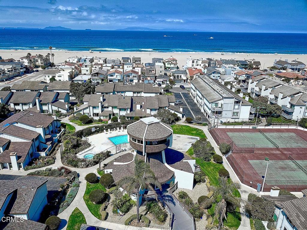 Welcome to Harbor Walk, your gateway to the coastal charm of Hollywood Beach & the vibrant life of Channel Islands Harbor. Perfectly positioned between Malibu & Santa Barbara, this seaside enclave offers the ultimate SoCal lifestyle. Spend mornings beachcombing golden sands, afternoons kayaking through the marina & evenings dining at harbor-view restaurants. With yacht clubs, bike paths, boutique shopping & year-round events, Harbor Walk is more than a neighborhood, it's a lifestyle. A short stroll takes you to the beach, the harbor, or your favorite paddleboard launch. Whether you're chasing sunsets or sea breezes, this is the beachy Shangri-La you've been dreaming of.Tucked within this resort-like community featuring sparkling pools, bubbling spas, tennis courts, and a clubhouse is your beach-inspired retreat. This upgraded home offers an airy, open-concept design with vaulted, beam-accented ceilings and abundant windows that flood the space with natural light. The coastal breeze drifts through the spacious living room, where a fireplace with luxury designer tile & wood beam hearth sets a cozy, elegant tone. Custom window treatments & wainscoting add touches of style throughout.Step onto the balcony for peekaboo ocean views, or head into the sparkling kitchen with butcher block countertops, farm house sink, top-tier appliances & harbor views, ideal for entertaining or savoring a quiet morning coffee. The primary suite is peaceful & private, while the upstairs loft functions perfectly as a second bedroom or creative flex space with additional harbor views. The updated bath features a travertine-style tile shower, frameless glass doors & refined finishes.Enjoy the rare bonus of a 2 car garage with ample room for bikes, boards, or beach gear. Whether you're living full time or weekending by the water, this home checks every box. Coastal bliss, turnkey style & unbeatable location, it's all here. Come for a day, stay for lifetime!