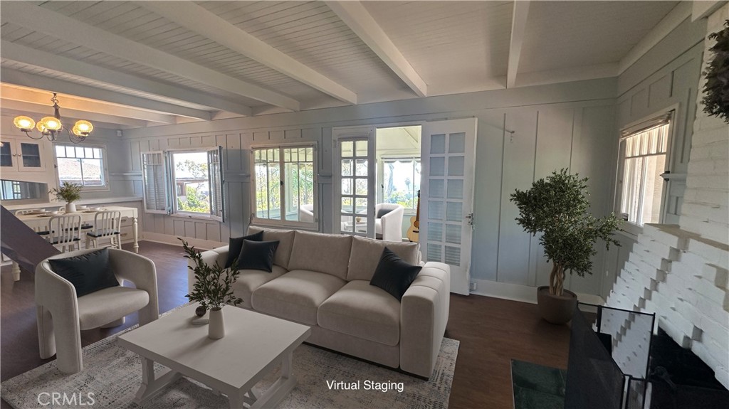 The 1913 Crown Jewel of North Laguna – A Timeless Hideaway with Ocean Views - Short walk to town and beach!
Tucked discreetly behind lush foliage and nestled among the storybook charm of North Laguna, this historic masterpiece invites you into a world where craftsmanship, character, and coastal serenity converge.
Perched on an expansive 5,000 square-foot lot, every inch of this residence speaks of enduring care and integrity, from its solid wood floors to its hand-hewn beams and signature brick fireplace.
Step through sunlit rooms filled with original windows that draw in the blue ocean like a canvas. The 1000 sq ft main floor features spectacular sit-down ocean views from all of the windows, and a warm and welcoming 1-bedroom, 1-bath with a walk-in shower. A finished attic —complete with an electronic, finely crafted wood staircase, features a large ocean view picture window, vintage wood paneling, a quarter bath, closets, and storage—perfect as a writer’s nook, artist retreat, office, or playroom. This space is not included in the sq ft., and is approx 800 sq ft. Change it into a spiral staircase, or even a tube elevator!
The large finished lower level (the size of the main level) has a half bath, laundry area, and an abundance of storage; an ideal space for a studio, office, gym, theatre or private guest suite. An enclosed original porch enhances the sense of intimacy and character throughout.
Step outside to curated gardens and a charming brick patio where time slows, and entertaining becomes an art. A detached two-car garage and newer HVAC system bring modern ease without sacrificing charm. A side gate allows for easy access to the alleyway.
This is a fabulous opportunity to live the Downtown Laguna Beach Lifestyle! Be a part of Laguna's renowned history. Let's go! Bring your imagination!
PRIME LOCATION! Walk to Main Beach, downtown galleries, and boutique cafés—all just moments from your door.
Laguna’s Crown Jewel is calling. Will you answer? Listing includes supplements- Records with building permits and Appraisal. NOTE: Appraisal does not include the finished second story and bathroom, but comes in at almost $3.3. Sq. footage in MLS does not include the attic. Remodel the entire interior to your liking!