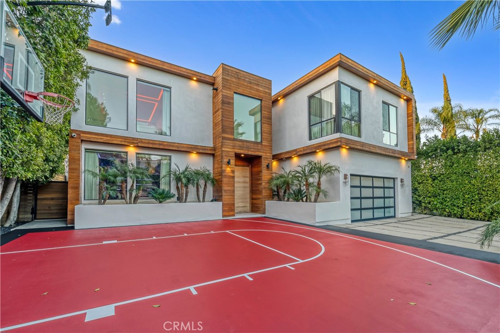 Tucked behind 10-foot privacy gates in one of Encino's most exclusive SOUTH OF VENTURA pockets, this stunning GATED, PRIVATE estate blends sleek modern design with true resort-style living. Over $1.5M in luxury upgrades include paid-off solar, TOP TIER security SYSTEM, LED lighting, and floor-to-ceiling shatterproof glass windows that flood the open-concept layout with natural light. Inside, enjoy marble flooring and finishes, soaring ceilings, and a seamless flow ideal for entertaining. The chef's kitchen opens to expansive living areas and a main-level bedroom suite. The oversized primary retreat offers double door entry, two custom walk-in closets, a spa-like bath with Jacuzzi tub, and a private balcony overlooking the backyard.
Outdoors, experience true paradise with a heated pool, separate spa, water fountain, basketball court, and full surround sound. A rare professional recording studio, ample gated parking, 2 Car garage with direct access, EV Charger and abundant storage complete this incredible offering. Award winning schools, close to shops and fine dining.
Fully loaded, ultra-private, and turn-key—this is modern luxury living at its finest in prime Encino