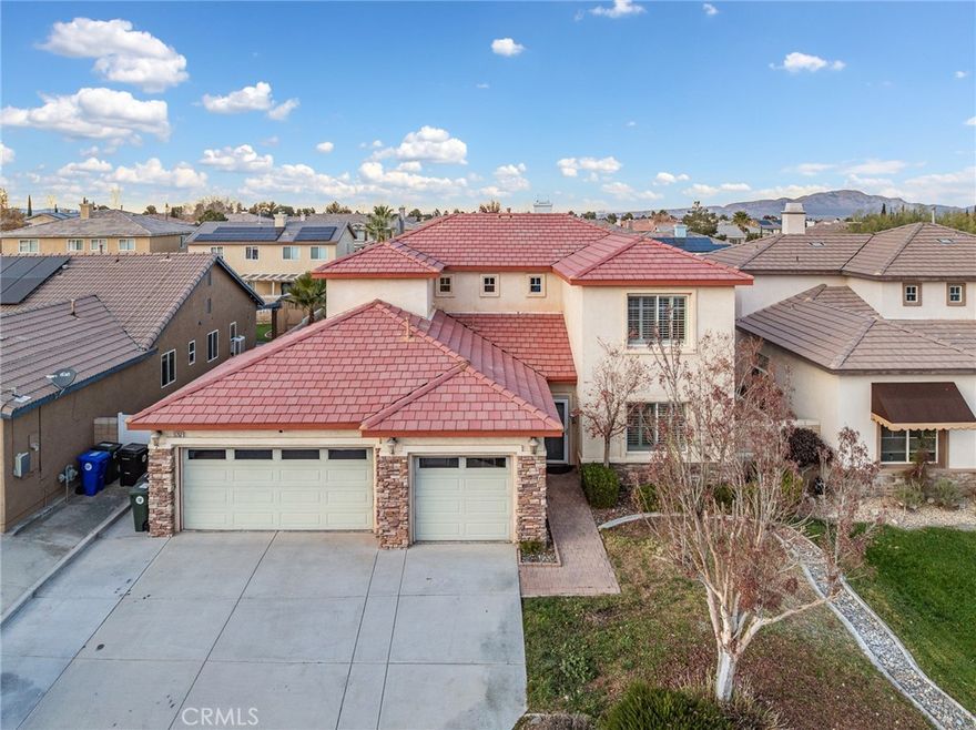 SPACIOUS TWO-STORY HOME WITH FIRST-FLOOR SUITE, LOFT & 3-CAR GARAGE — NEAR SCHOOLS & FREEWAY. This well-designed two-story home offers a versatile layout with space to live, work, and gather comfortably. Featuring approximately 2,696 sq ft, the floor plan includes a convenient first-floor mini suite, ideal for guests, extended family, or a private home office. The heart of the home is the open kitchen, which flows seamlessly into the family room with a fireplace, creating a warm and inviting space for everyday living and entertaining. Throughout the home, plantation-style shutters add both style and energy efficiency. Upstairs, the primary bedroom suite provides a private retreat, accompanied by two additional bedrooms, a spacious loft, and a full hallway bathroom—perfect for flexible living or play space. A half bath is conveniently located near the front entry on the main level. Additional highlights include an indoor laundry room just off the garage entry with abundant storage. The three-car garage features an additional rear-facing garage door, allowing easy access to the backyard—ideal for outdoor projects or added functionality. Step outside to enjoy the covered back patio, perfect for outdoor dining or relaxing. Centrally located near shopping, freeway access, and both elementary and high schools, this home offers comfort, convenience, and a thoughtfully designed layout suited for a variety of lifestyles.