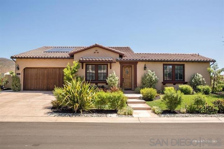 Situated in the prestigious guard gated community of The Lakes, this magnificent Belleza home features a generous corner lot with panoramic mountain vistas. Built in 2012 by Lennar Homes, this single level residence offers a flexible layout with 3 bedrooms plus a den which could be used as a bedroom, office or playroom. The gourmet kitchen features GE Monogram stainless steel appliances, granite kitchen countertops, a large island, and walk in pantry. Adjacent to the kitchen is a formal dining room with a full wet bar with beer tap and a 400 bottle wine cellar. The spacious great room leads to the center courtyard complete with a hot tub. Step outside to a backyard built for entertaining complete with an outdoor kitchen, patio with fire pit, multiple fruit trees (apple, lemon, pomegranate, mango), and grassy play areas. Additional upgrades include Sunrun solar system and an epoxy-finished 3 car garage. The Lakes, one of North County San Diego’s most sought-after luxury communities, offers hiking trails, lakes and open spaces. The Lakes is part of the acclaimed Poway Unified School District.