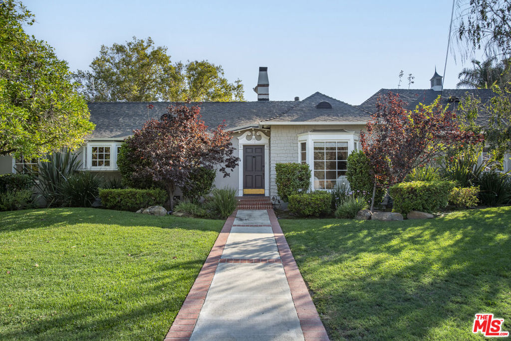 LARGE FLAT LOT...On a quiet cul-de-sac in coveted Woodbridge Park, this sprawling single-level traditional delivers the best of Studio City living just moments from Ventura Blvd and Tujunga Village. Past the sweeping lawn and brick porch, wood floors lead to a sunlit family room with fireplace and a stylish formal dining room. The oversized eat-in kitchen with center island and updated appliances flows to a second living room with fireplace, then out to a covered patio and expansive backyard built for entertaining. Four bedrooms and 2.5 baths include a serene primary suite with dual vanity and walk-in shower. A two-car garage with EV charger, inside laundry, central HVAC, and ample attic storage complete this Woodbridge Park gem.