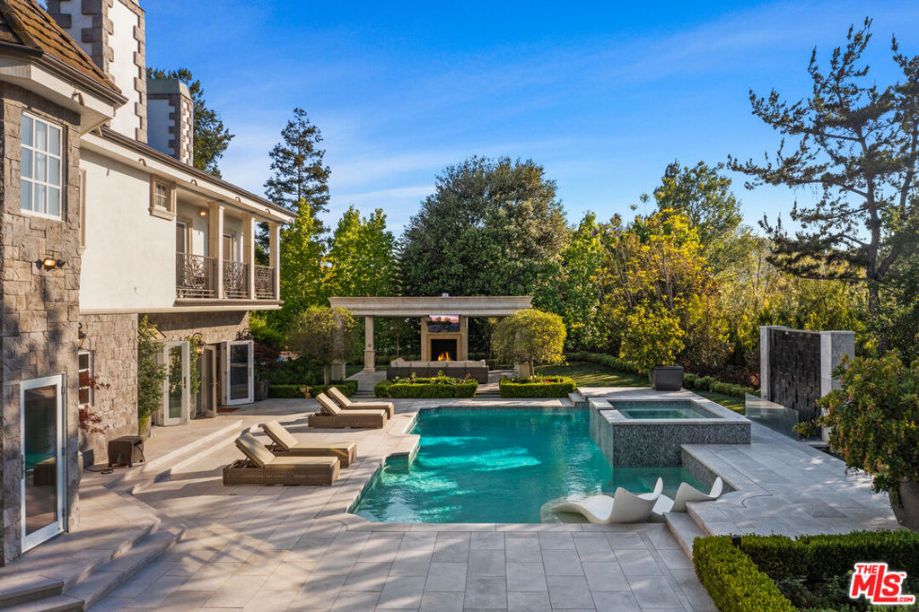 Experience the pinnacle of luxury living in this fully furnished, double-gated modern estate in Bel air, offering flexible lease terms. Spanning nearly 8,000 square feet on a lush, park-like acre, this architectural masterpiece boasts 5 lavish bedrooms, including a grand primary suite with a private seating area, dual spa-like baths, and custom-designed closets, plus two versatile flex rooms ideal for a home office or gym. Designed for seamless indoor-outdoor living, the home features a gourmet chef's kitchen with top-tier appliances, elegant formal dining and living areas, a state-of-the-art wine cellar with an intimate poker lounge, and smart home technology throughout. Step outside into a resort-style backyard oasis, complete with a pristine swimming pool, multiple lounge areas, BBQ, fire pit, private basketball court, putting green, and immaculate gardens, offering unparalleled privacy and tranquility. Conveniently located just minutes from the Beverly Glen Centre, this estate is perfect for those seeking exclusivity, elegance, and convenience. Short-term and long-term leases available, with pricing upon request for leases under one year.