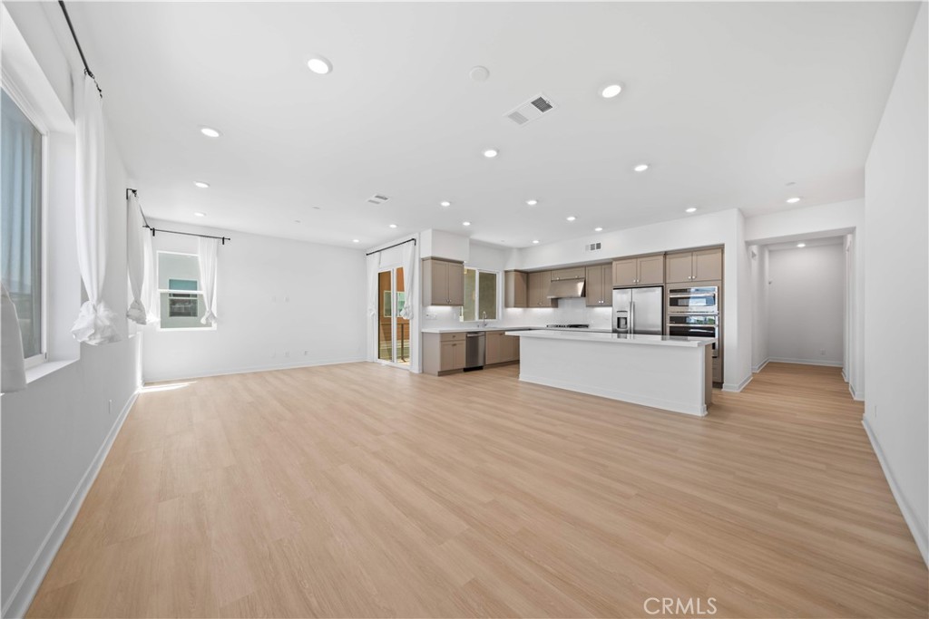 Welcome to this thoughtfully designed tri-level townhome in a prime Irvine location—just steps from the award-winning Portola High School! This spacious and functional layout offers 3 bedrooms, 3.5 bathrooms, and a versatile loft space, perfect for a home office or additional family room. The first level features a convenient two-car attached garage, complete with a Tesla EV charger for effortless daily charging.. As you head upstairs, the second floor welcomes you with an open-concept living room, dining area, and modern kitchen, seamlessly connected to a cozy balcony—ideal for relaxing or entertaining. This level also includes a private ensuite bedroom and a powder room for guests. The main entry door from within the building also opens to this level for added accessibility. The third floor showcases a bright loft area with a second balcony, a generously sized primary suite, and an additional secondary bedroom and bath. As a bonus, an extra private storage room is conveniently located directly across from the main entrance—perfect for seasonal items, sports gear, or luggage. Enjoy additional peace of mind and long-term savings with a fully paid-off solar system. Best of all, Portola High School is directly across the street—a one-minute walk to one of Irvine’s top-rated schools! Whether you're a first-time buyer or a young family starting out, this home offers exceptional value in one of Irvine’s most desirable Great Park community. Enjoy all the amazing amenities of the Great Park Neighborhoods, including its parks, clubhouse, heated pools, hot tubs, sports courts and fields, playgrounds, and picnic areas. Don’t miss this rare opportunity to own a stylish and affordable home in an unbeatable location!