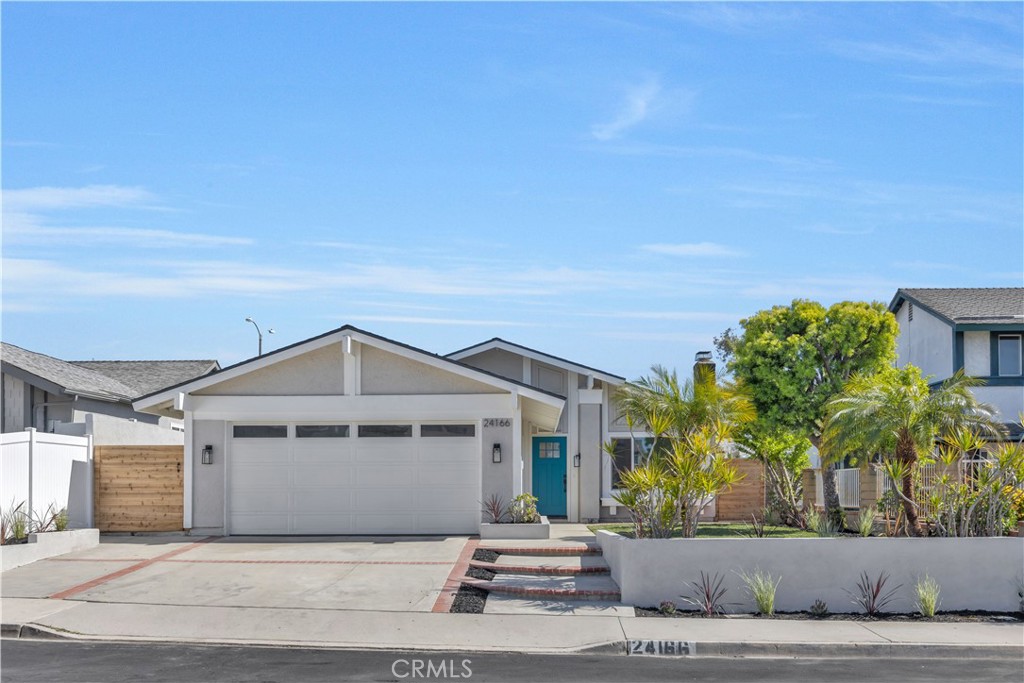 Welcome to 24166 Fortune Dr, a beautifully remodeled single-story home in the heart of the beloved South Orange County. Boasting a brand-new roof and an exquisite modern design, this three-bedroom, two-bathroom home seamlessly blends contemporary style with warm, natural elements.
Step inside to an open and inviting living space, featuring a sleek black fireplace as the focal point, complemented by recessed lighting and wide plank wood flooring. The gourmet kitchen is a showstopper, with custom two-tone cabinetry, quartz countertops, a farmhouse sink, and stainless steel appliances. A cozy dining nook with a statement light fixture adds a touch of rustic charm.
The primary suite is a serene retreat, with a spacious layout, large window overlooking the backyard, and an ensuite restroom with a luxurious tiled shower. The guest bathroom features stunning green vertical subway tiles, a built-in niche, and matte black fixtures.
Enjoy seamless indoor-outdoor living with a private backyard oasis, featuring a newly built pergola-covered patio, lush landscaping, and ample space for entertaining.
Additional upgrades include a brand new roof, new windows, waterproof wood flooring throughout, designer finishes and fixtures, upgraded bathrooms with custom tile work, and modern black and gold hardware accents.
Nestled in a peaceful neighborhood, this home is conveniently located near schools, shopping, and the freeway for an easy commute. With its impeccable upgrades and move-in-ready charm, 24166 Fortune Dr is a rare find.