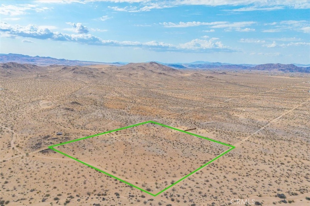 Set in one of the most sought-after pockets of North Joshua Tree, this rare 10-acre parcel offers the ideal canvas for your dream desert home. With city water connection eligibility and Edison power already on the southwest corner, utilities are within easy reach. The land features a mix of gentle rolling hills and flat buildable pads, allowing for flexible architectural possibilities and seamless integration with the landscape. Take in uninterrupted 360° views of the desert, surrounding mountains, and stunning sunrises and sunsets. Whether you're building a personal retreat or future investment, this parcel is perfectly priced and primed for development. Opportunities like this in Joshua Tree’s high-demand areas are increasingly rare—don't miss your chance to claim your own piece of the desert.