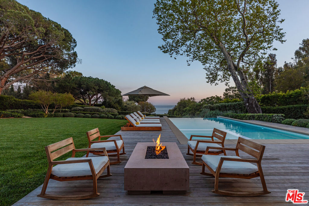 Tucked away in Malibu's most sought-after gated beach community, this extraordinary 1.1-acre estate in Paradise Cove seamlessly unites two legal parcels into one of the area's most distinguished offerings. With unparalleled access to Malibu's iconic shoreline, the property presents a rare blend of refined design, privacy, and coastal beauty. Inspired by the timeless vision of Cliff May, the over 4,000-square-foot main residence exudes sophistication with white oak floors, hand-troweled plaster walls, and meticulously curated designer finishes. The open-concept living room, den, and gourmet chef's kitchen flow effortlessly onto a sweeping IPE deck, expansive grassy lawn, and a dramatic infinity-edge pool each space framing uninterrupted views of the Pacific Ocean. The primary suite is a serene sanctuary, featuring soaring ceilings, a cozy fireplace, a boutique-style walk-in closet, and a spa-inspired bathroom adorned with Calacatta Viola marble and Waterworks brass fixtures. Three additional bedrooms and two-and-a-half luxurious baths complete the main home. Set amid lush, professionally landscaped gardens by Eric Gomez, the estate continues with a fully reimagined 2,500-square-foot guest house. Originally designed by Doug Rucker and thoughtfully transformed by Bridgette Romanek - named one of Elle Decor's Top 50 designers - this second residence offers an ocean-view primary suite, two additional bedrooms, steel-framed doors and windows, a game room, elegant living spaces, and a designer kitchen. Additional highlights include a second gated motor court, a two-car garage, and a private, regulation-size tennis court crowned by a striking Renson glass and steel pavilion creating an unparalleled environment of comfort, recreation, and coastal luxury.