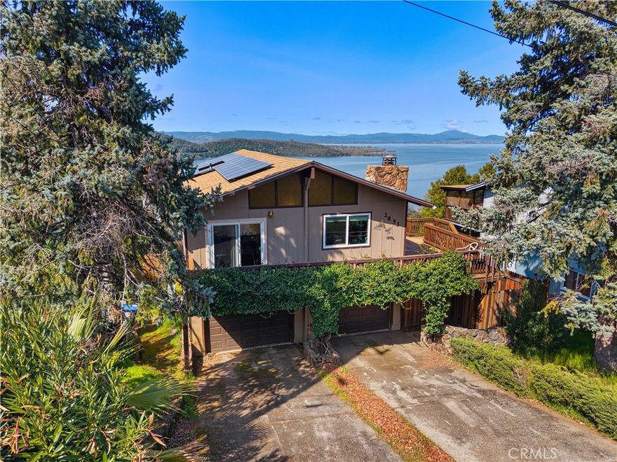 Bring your vision and creativity to this Riviera Heights home with stunning panoramic views of Clear Lake! While the property needs work, it offers incredible potential. Expansive decks capture breathtaking lake vistas, providing the perfect backdrop for entertaining, relaxing, or reimagining outdoor living spaces. Inside, vaulted ceilings, three sliding glass doors, and a cozy fireplace create an open and inviting atmosphere. The main level includes two bedrooms, two bathrooms, a dining area, a spacious living room, and a recently updated kitchen. Downstairs, you’ll find a separate unit with its own living area, kitchenette, bedroom, and bathroom—ready for your finishing touches to maximize its potential as guest quarters, extended family space, or rental income. The home also includes a two-car garage and a large fenced yard, ideal for gardening, pets, or future landscaping projects. Located in the desirable Riviera Heights community, residents enjoy access to a clubhouse, swimming pool, private marina, and boat launch. Just minutes from Clear Lake, local wineries, and outdoor recreation, this property offers an exciting opportunity to renovate and create your dream retreat in Lake County.