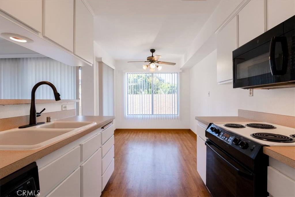 Welcome to Carroll Park East, a secure and well-maintained condominium community located in one of Long Beach’s most desirable historic neighborhoods. This spacious one bedroom, one bathroom home offers 792 square feet of living space with an open floor plan and abundant natural light. The living room features large sliding glass doors that open to a private balcony, creating a seamless indoor-outdoor flow. The kitchen includes white cabinetry, ample counter space, and a breakfast bar that opens to the living room. The dining area is filled with natural light from a large window, and the bedroom is generously sized with excellent closet storage. The bathroom offers a wide vanity with plenty of counter space. The building is surrounded by lush landscaping and is close to the beach, Bluff Park, Retro Row, and the many shops and restaurants that make Long Beach such a vibrant community.