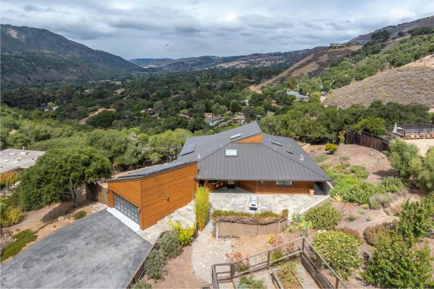 Stunning views from this show-stopping, mid-century modern, single-story home situated on an acre. Extensively remodeled in 2013-meticulously maintained. Great floor plan, gorgeous hardwood floors, beautiful open kitchen, vaulted ceilings, dual fireplace, bank of windows with remote control window coverings that deliver spectacular valley views. The primary suite is a dream taking full advantage of the view, with a dramatic fireplace, sliding doors, closets with custom built-ins and lovely primary bathroom. Enjoy dinner on the west-facing deck, capturing dramatic sunsets. Indulge in a hot tub soak under a canopy of stars. The second bedroom is also generous and enjoys a large spa-like hall bathroom. There is a built-in desk area, spacious laundry room and ample storage throughout the house.  Large slate sun-drenched patio offers a fantastic expansion of outdoor living space for entertaining and gathering. Flourishing vegetable, flower garden & several fruit trees all set among modern and native landscaping. An ultra-finished garage with an electric car plug-in and built-ins provides a very nice extra space. This home boasts an amazing valley location. Updates include a durable 50-year standing seam metal roof. 7.8 KWp solar system. Water West may also offer more water if desired.