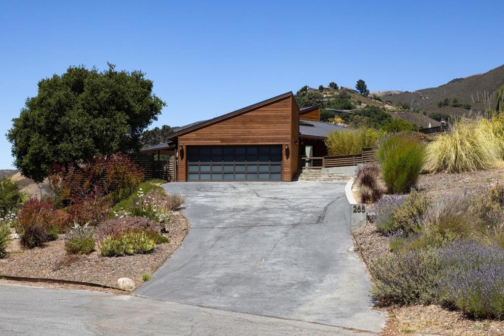Stunning views from this show-stopping, mid-century modern, single-story home situated on an acre. Extensively remodeled in 2013-meticulously maintained. Great floor plan, gorgeous hardwood floors, beautiful open kitchen, vaulted ceilings, dual fireplace, bank of windows with remote control window coverings that deliver spectacular valley views. The primary suite is a dream taking full advantage of the view, with a dramatic fireplace, sliding doors, closets with custom built-ins and lovely primary bathroom. Enjoy dinner on the west-facing deck, capturing dramatic sunsets. Indulge in a hot tub soak under a canopy of stars. The second bedroom is also generous and enjoys a large spa-like hall bathroom. There is a built-in desk area, spacious laundry room and ample storage throughout the house. Large slate sun-drenched patio offers a fantastic expansion of outdoor living space for entertaining and gathering. Flourishing vegetable, flower garden & several fruit trees all set among modern and native landscaping. An ultra-finished garage with an electric car plug-in and built-ins provides a very nice extra space. This home boasts an amazing valley location. Updates include a durable 50-year standing seam metal roof. 7.8 KWp solar system. Water West may also offer more water if desired.