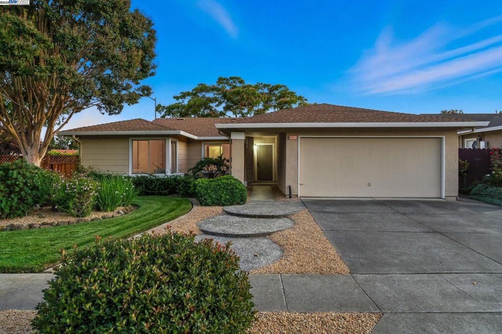 This beautifully updated single-story home offers 4 bedrooms, 2 baths, and 1,467 sq ft of refined living space on a spacious corner lot within a quiet court. The interior showcases soaring vaulted ceilings, wide-plank luxury vinyl flooring, fresh interior paint, ceiling fans, designer lighting, and upgraded hardware throughout. The living room is warm and inviting with a striking fireplace and a large picture window framing views of the lush backyard. The gourmet kitchen has been tastefully remodeled with sleek quartz countertops, a subway tile backsplash, stainless steel appliances, and a kitchen-family room combo that enhances flow and function. The spacious primary suite also features vaulted ceilings, creating a bright and airy retreat. Both bathrooms offer a spa-like feel with quartz vanities, modern mirrors, and stylish new fixtures. Step outside to a park-like backyard with mature trees, a verdant lawn, patio, Trex deck, and an extended side yard—ideal for entertaining or relaxing. Additional upgrades include ceiling fans and an all-new electric panel for peace of mind. Conveniently located near 680, 880, 84, downtown, and major tech companies, this home blends comfort, elegance, and everyday ease in a truly elevated setting.