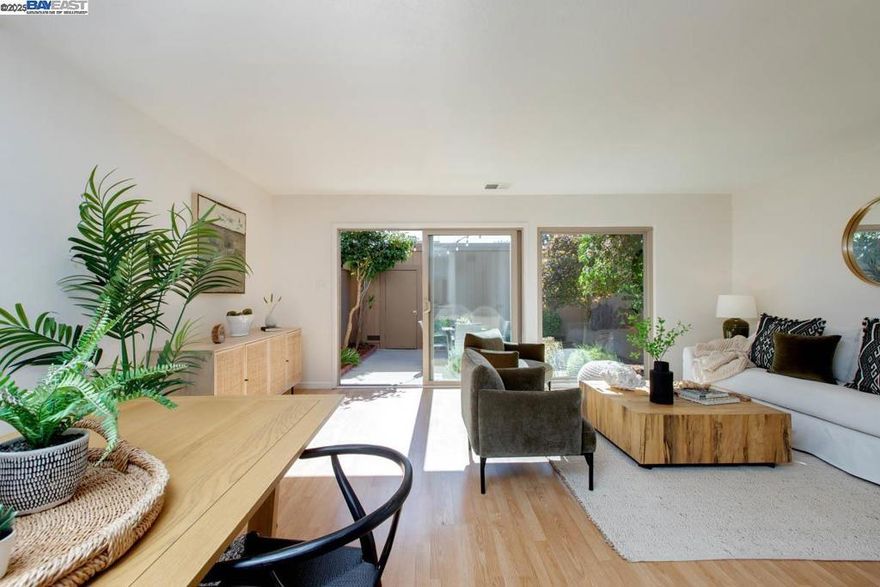 Located in Bay Farm Island's well-established Islandia HOA community, this beautifully updated two-story townhome features 2 BR, 1.5 BA, an open LR/DR/kitchen, laundry room, detached 2-car garage and a sunny patio + garden w/mature landscaping. The contemporary open floor plan is enhanced by sliding doors that provide bright, natural light and seamlessly connect the interior to the private patio & attractively landscaped garden. Details include wood-like floors, refreshed interior paint + new lighting throughout. The main level 1/2 bath has been remodeled w/attractive modern finishes, and the newly updated kitchen includes quartz counters, a new range, an LG refrigerator and Bosch dishwasher. The primary bedroom has a vaulted ceiling, a double closet w/custom organizers, plus a gorgeous ensuite bathroom with an oversized wet room-style shower with a soaking tub inside. The large detached garage (429 SF, measured) provides a flex space for parking, a workshop or additional household storage. Situated just minutes to highly ranked schools, parks, playgrounds, Harbor Landing shopping & the SF Ferry for an effortless ride to San Francisco. HOA amenities include a community pool & clubhouse. Enjoy resort-like living from this move-in-ready home in a desirable Bay Farm location!