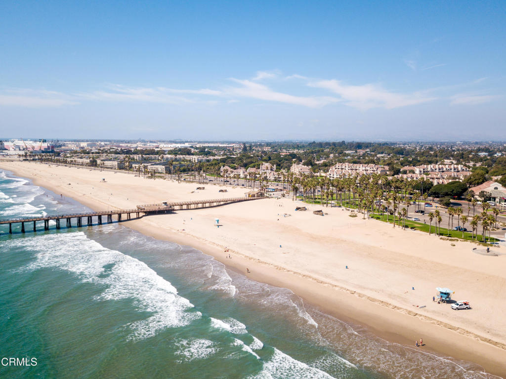 What's Special: Absolutely stunning, panoramic ocean views from this top-floor 2BR/2BA condo in the gated Surfside IV community--directly across from Port Hueneme beach and pier. Enjoy ocean and whitewater views the moment you walk in. Rare elevator-access top-floor unit with soaring ceilings and an open layout. The spacious eat-in kitchen features upgraded appliances, plus a formal dining area and sunken living room with gas fireplace and patio access. Upgrades include bamboo flooring, new carpet in living areas and bedrooms, dual-pane windows, and remodeled bathrooms. The primary suite offers direct ocean views, patio access, a soaking tub, shower, and dual vanities. Ceiling fans in both bedrooms and dining room. Laundry closet with side-by-side washer and dryer. Includes a one-car garage and two unassigned parking spots. Community clubhouse features a fitness center, full kitchen for events, library, game room with Ping-Pong and billiards, piano, sauna, remodeled year-round heated pool and spa. Rooftop deck for July 4th fireworks and mountain views. Moranda Park just behind the complex with lighted pickleball and tennis courts. Perfect as a primary home or vacation getaway!