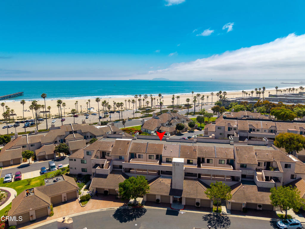 What's Special: Absolutely stunning, panoramic ocean views from this top-floor 2BR/2BA condo in the gated Surfside IV community--directly across from Port Hueneme beach and pier. Enjoy ocean and whitewater views the moment you walk in. Rare elevator-access top-floor unit with soaring ceilings and an open layout. The spacious eat-in kitchen features upgraded appliances, plus a formal dining area and sunken living room with gas fireplace and patio access. Upgrades include bamboo flooring, new carpet in living areas and bedrooms, dual-pane windows, and remodeled bathrooms. The primary suite offers direct ocean views, patio access, a soaking tub, shower, and dual vanities. Ceiling fans in both bedrooms and dining room. Laundry closet with side-by-side washer and dryer. Includes a one-car garage and two unassigned parking spots. Community clubhouse features a fitness center, full kitchen for events, library, game room with Ping-Pong and billiards, piano, sauna, remodeled year-round heated pool and spa. Rooftop deck for July 4th fireworks and mountain views. Moranda Park just behind the complex with lighted pickleball and tennis courts. Perfect as a primary home or vacation getaway!