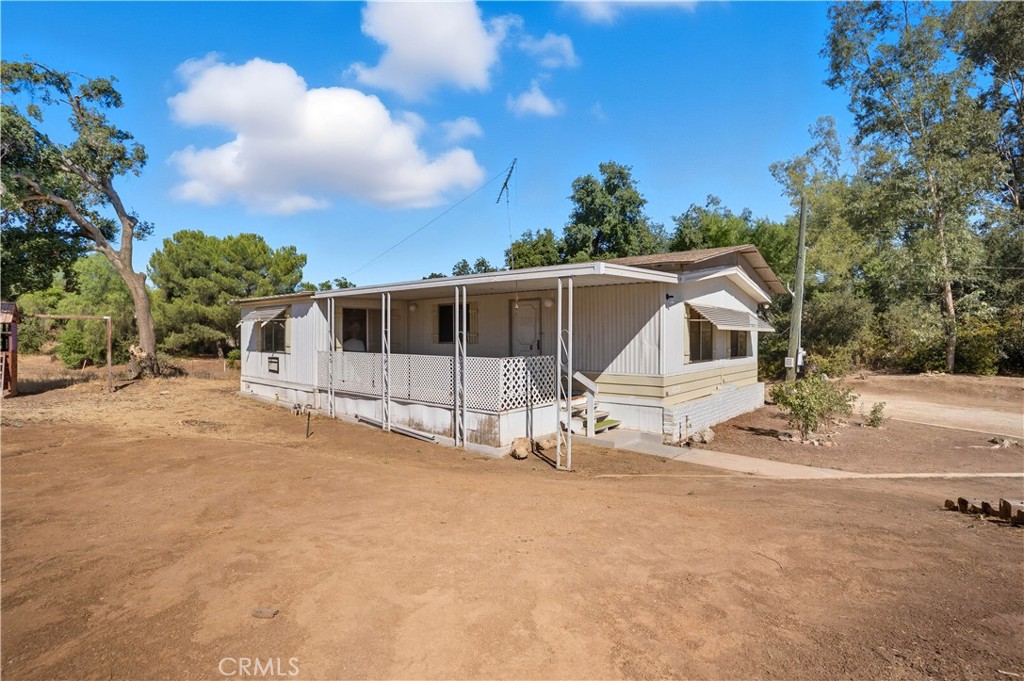 Welcome to this 3-bedroom, 2-bath home set on a expansive 36,500 sq. ft. lot in the heart of Menifee. This property offers incredible potential for buyers looking to create their dream home or investment. Inside, you’ll find a well-designed floor plan with a large living area, functional kitchen, and three comfortable bedrooms. The home is situated on a recorded 433 permanent foundation, making possible the eligibility for financing. While the property needs updating, it has solid bones and offers the perfect canvas for renovation and personalization. The oversized lot provides endless opportunities—whether you envision adding a shop, RV/boat parking, a pool, or even creating your own mini ranch. With plenty of usable land and room to expand, this property is ideal for those who need space and flexibility. No HOA and low taxes make it even more desirable. Conveniently located near shopping, schools, and freeway access, this Menifee home blends rural charm with city convenience.