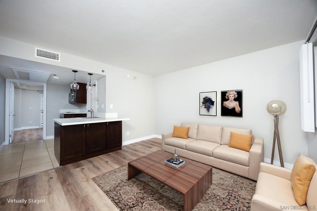Discover this charming 1-bedroom, 1-bathroom condo on the fourth floor, located just one mile from the San Diego Bay. With new luxury vinyl plank (LVP) flooring and fresh paint throughout, this unit is as inviting as it is comfortable. The large windows allow for refreshing crossflow natural ventilation, keeping the space cool and airy. The kitchen and bathroom have been remodeled, and feature updated cabinets, pendant lighting, and stainless steel appliances. This unit features a private balcony and one assigned parking space in the indoor parking structure. The Bay View Tower complex offers excellent amenities, including a gym, laundry, pool, spa, and a BBQ area - perfect for relaxing or entertaining. Its prime location is steps from the trolley & law school, is just one block from a grocery store, and provides easy access to the nearby military base, public transportation, and more. Plus, downtown San Diego and Balboa Park are only a 10-minute drive away, making this the perfect place to call home!