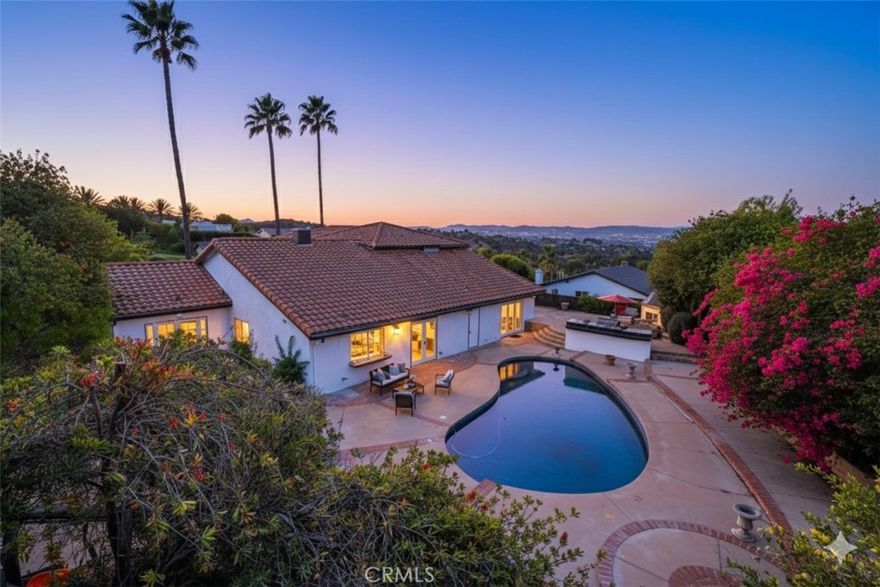 Welcome to 4424 Deanwood – An Exclusive Private Mediterranean Retreat with Breathtaking Panoramic Views.
Perched high above the city with sweeping vistas, this beautifully renovated Mediterranean estate seamlessly combines privacy, luxury, and practicality. Located behind a gated entrance on a 0.42-acre usable lot, this 3,781 sq ft home features 5 bedrooms and 5.5 bathrooms, complete with a top-to-bottom remodel.
Upon entering, you'll be greeted by soaring vaulted ceilings, floor-to-ceiling fireplace, and an open-concept layout. Newly installed white oak hardwood floors and abundant natural light emphasize the home's sophisticated finishes and timeless style.
The heart of the residence is a chef’s dream kitchen—equipped with dual ovens, stainless steel appliances, brand-new custom cabinetry, and a spacious center island with quartz countertops. Perfect for entertaining or family cooking, this kitchen blends style with functionality.
The main level includes three generously-sized bedrooms, including a secondary suite with a private bath—ideal for guests or extended family. A large office featuring a custom wet bar offers versatility and can easily be converted into a sixth bedroom or creative space.
Upstairs, the primary suite is a luxurious sanctuary—boasting a private balcony, a bonus room suitable for an office, nursery, or safe room, and stunning views. The spa-inspired ensuite features a soaking tub overlooking the mountains, dual vanities, a dedicated makeup vanity, and two fully built-out walk-in closets.
Step outside to your resort-style backyard—featuring a sprawling deck, pool, bar, built-in BBQ, fire feature, and a separate pool bathroom with shower. It’s an entertainer’s paradise, offering ample space to host, relax, and enjoy year-round indoor/outdoor living.
Whether seeking a peaceful family retreat or a stunning home designed for entertaining, 4424 Deanwood presents a rare opportunity to own a truly spectacular piece of real estate.
Don’t miss your chance to make this extraordinary property your new home.