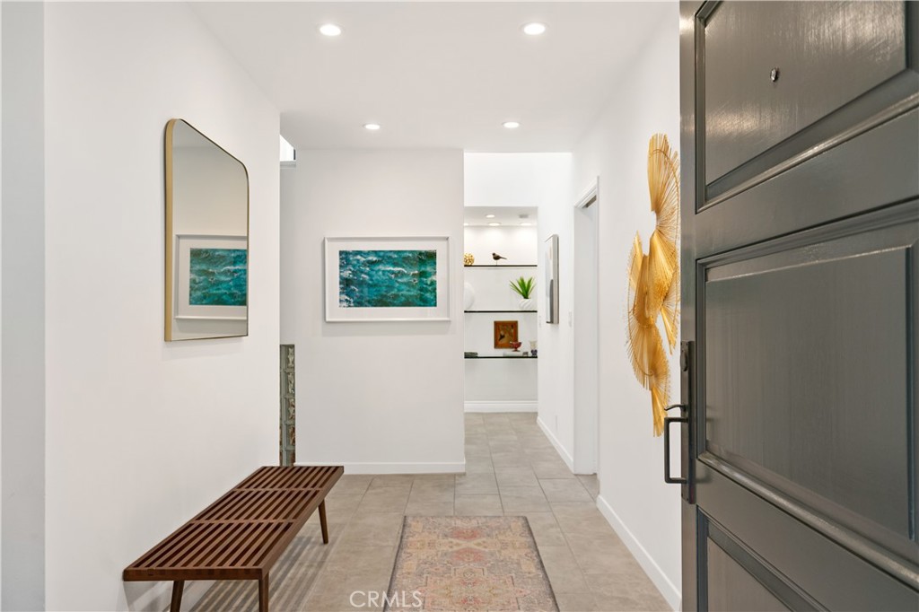 Discover architectural elegance and modern comfort at 1156 S Carmelina Ave, a stunning 4-bedroom, 5-bathroom multi-level retreat in coveted Brentwood. Designed to inspire, this solar-powered home features vaulted ceilings, dramatic skylights, and a graceful rounded stairway that flows through sunlit, open spaces.
The chef’s kitchen boasts an island layout, outdoor access, and nearby laundry for effortless function. Entertain in the soaring living room, dine in style with a built-in bar area, or host guests in the main-level ensuite bedroom. The lower level offers a versatile home office or guest suite with French doors, plus an additional ensuite bedroom.
Elevated on the top floor, the expansive primary suite feels like a private resort with dual walk-in closets, a romantic fireplace, balcony, soaking tub, and dual vanities.
Step outside to a lush tropical paradise featuring a turf lawn, tranquil fountain, mature landscaping, and hardscaped patio—all tucked behind tall foliage and full fencing for ultimate privacy. The private front courtyard offers an additional space to relax or entertain.
Just one block from Santa Monica and minutes from the beach via bike-friendly streets, this serene escape blends luxury, privacy, and premier Westside living. A rare find you’ll want to experience in person.
