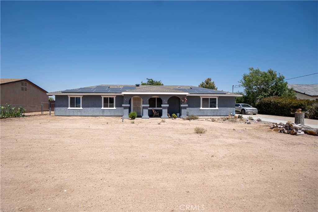 DESIRABLE MESA HESPERIA NEIGHBORHOOD HOME!! Adorable 3 bedrooms, 2 full bath home, about 1200 square feet of living spaced with 2 car attached garage, and about 1/2 an acre land. Property has chain-link fencing all around, cross fences on the both sides with gates. Seller has poured ton of extra concrete to widen driveway for additional parking. Front covered porch. Solid front wood door with screen door opens to the spacious living room. Country Kitchen: beautiful solid oak wood cabinets, granite counters, deep stainless-steel sinks with pull down faucet. Dining area next to the Kitchen has French door to th back covered patio. All bedrooms are good size with ample closet spaces. Custom 18-inch tile flooring throughout entryway, hallway, bathrooms, Dinning and Kitchen flooring. DONT PAY FOR POWER! Seller paid cash for an oversize 46 panels SOLAR system! Seller also has put in a newer roof about10 years ago, refurbished the AC system 5 years ago, and water heater is only 2 years old. Live peaceful with all the conveniences are less than 10-minute way. This is a lot of houses for such a little price!! MUST SEE TO APPRECIATE!!