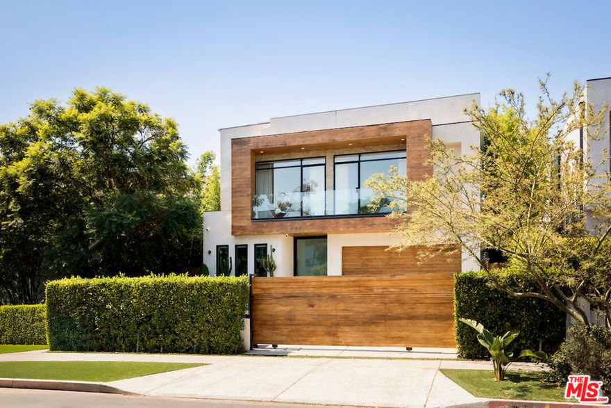 House of Shoor brings Minimalism to life in this 6,500+ square-foot residence set in the heart of the Melrose Arts District." The five-bedroom, six-bathroom floor plan showcases a resort-style primary suite, a private home theater, and an entertainer's backyard complete with a pool, lounge, and dining areas. At the heart of the home, the kitchen is outfitted with state-of-the-art Miele appliances and anchored by a striking hand-carved stone island. Designed with intention, the expansive open layout creates a seamless flow to the serene, secluded backyard, while a rooftop deck delivers unobstructed 360-degree views of the city skyline. Free of unnecessary ornamentation, the architecture embodies the essence of minimalismclean lines, natural materials, and thoughtfully integrated spacesresulting in a tranquil, luxurious retreat tucked into the energy of one of the world's most dynamic neighborhoods.