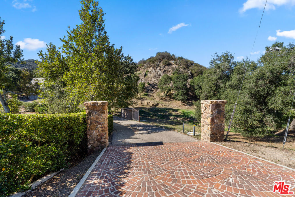 This exceptional development opportunity is now back on the market with a substantial price reduction. Spanning approximately 7.7 acres, it is nestled adjacent to the coveted E Carlisle neighborhood, adjacent to the Lake Sherwood residences. Whether your aspiration is to construct a spacious single family residence on the large cleared pad or to develop your own private compound, this property offers a blank canvas ready for your vision. Experience the luxurious privacy of canyon living while being just 5 minutes away from the premier shopping, dining, and outstanding education that Westlake Village has to offer. An adjacent lot is also available for purchase, featuring approximately 7 acres. Both lots are contiguous and are connected by an easement.