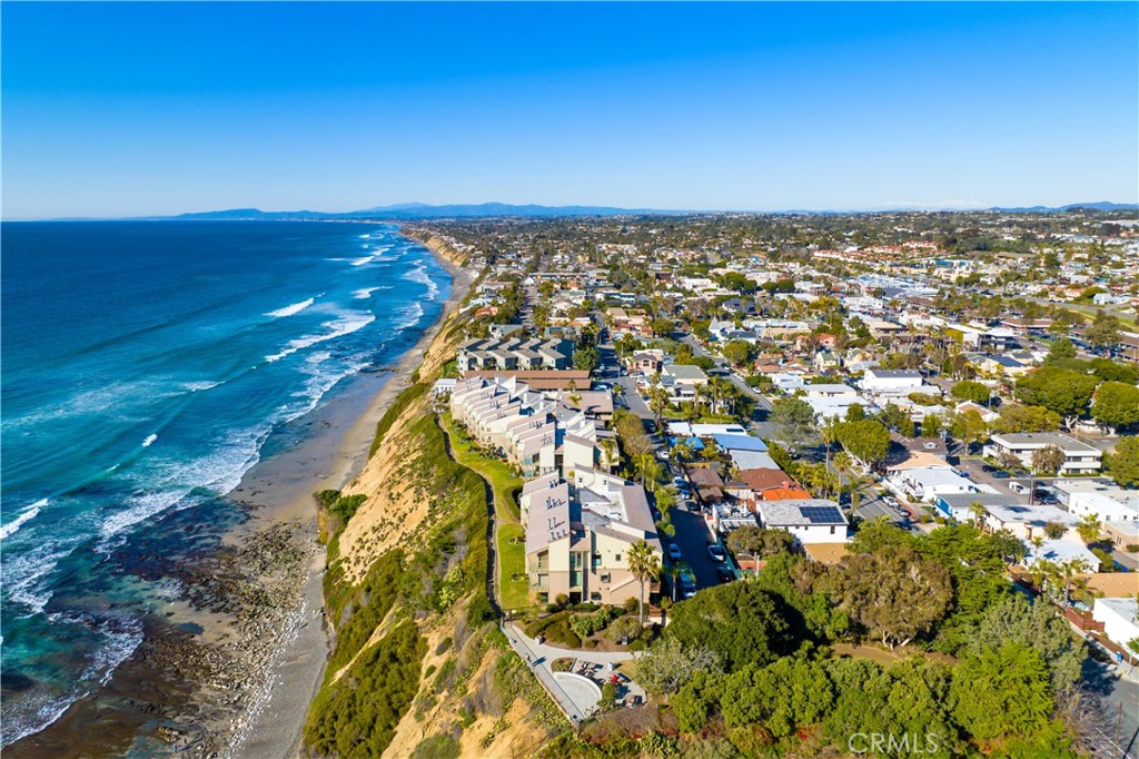 All you need are the keys to your fully furnished ocean paradise, offering brand new furniture! Waves crash at your feet in this new contemporary Beach Bungalow. Start living the dream of an Ocean Front residence in Encinitas, clearly the gem of the coast. Sunny corner location expands your panoramic view south creating a bright and airy feel. Remodel is complete and ready to view! New floors, bathroom cabinets and countertops. Designer inspired kitchen offers quartz counters, high end KitchenAid appliances, built in wine refrigerator, and double ovens . So much storage, featuring a walk in pantry and ample counter space., with two desks to keep you organized. Gourmet kitchen is an entertainer's delight with state of the art technology. Primary bedroom offers more sweeping ocean views, and built in cabinetry in the closet. Both bathrooms are highlighted by custom marble and quartz. Best of all home is equipped with Air Conditioning. Community includes gated entrance and parking, stunning pool and spa area. Located walking distance to local neighborhood restaurants and shops.