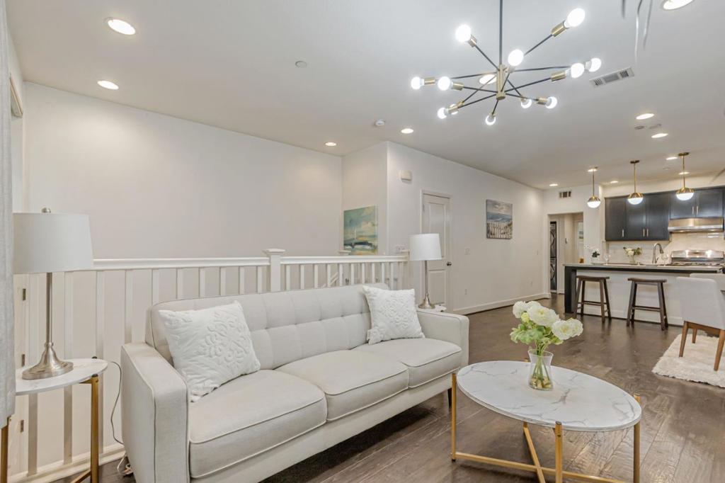 This beautiful and stunning 3 bedroom + Den/Office space + 2 bath home is located in the heart of Silicon Valley, offering comfort, style, and unbeatable convenience. Built in 2014 with many upgrades, it features a highly desirable floor plan with minimal stairs and thoughtful design throughout. Enjoy an open-concept layout with a gourmet kitchen showcasing granite countertops, a large island with large sink, marble backsplash, cherry wood cabinetry, and elegant hardwood floors. Dual vanities, a private patio/balcony, modern light fixtures, walking closet, high end stainless appliances and recessed lighting throughout. Designed for energy efficiency and year-round comfort with dual-pane windows, central A/C & heating, and a tankless water heater. Recent upgrades include fresh paint. laundry room, attached garage, and excellent proximity to freeways. Just a short walk to the Great Mall, BART, Light rail, Mattos School, Trader Joes, Starbucks, dining, retail, and a brand-new community park with modern playgrounds, open green space, picnic areas, and walking paths. Highly sought-after school district with nearby schools rated on GreatSchools: Mattos Elementary 10/10 for test scores), Rancho Middle School ( 9/10 for test scores), and Milpitas High School ( 9/10 for test scores).