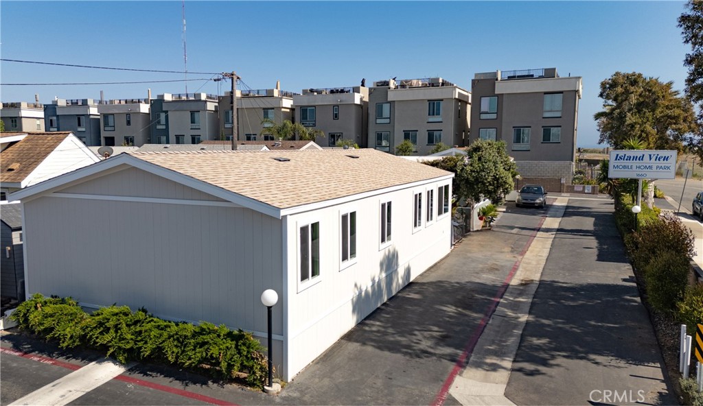 Completely upgraded coastal retreat with ocean views!! Welcome to this beautifully renovated 2-bedroom, 2-bath home in the highly sought-after 55+ Island View Mobile Home Park. This 1,056 sq. ft. mobile home features brand-new vinyl plank flooring throughout, new light fixtures and ceiling fans, and a new shingle roof. The kitchen offers all-new cabinets, quartz countertops, and updated appliances that create a fresh and inviting atmosphere. Both bathrooms are fully remodeled with luxury finishes and quartz counters. The spacious primary suite includes an en-suite bath and a walk-in closet. The second bedroom is perfect for guests, a home office, or a cozy retreat. Enjoy stunning ocean views from the living space and outdoor areas, plus the convenience of an individual laundry room. Turnkey and move-in ready—located just minutes from beaches, shopping, dining and more. This home is a rare opportunity for affordable coastal living without compromise.