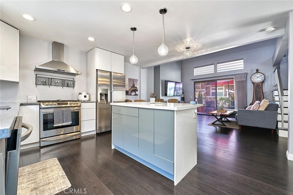 Modern comfort meets everyday convenience in this beautifully upgraded, end-unit condo nestled in one of La Habra’s most desirable communities. With only one shared wall, this home offers added privacy and a light, airy feel throughout. Step inside to discover soaring ceilings and rich dark laminate flooring that create a warm and inviting atmosphere from the moment you enter. The open-concept layout flows seamlessly into a fully renovated kitchen featuring sleek European-style custom cabinetry, including a hidden lazy Susan for added storage and functionality. The spacious island doubles as a breakfast bar and is topped with speckled quartz countertops, complemented by a full suite of stainless-steel appliances including a cooktop, oven, refrigerator, and dishwasher—making this space both stylish and practical for everyday living or entertaining. Upstairs, the spacious primary suite provides a peaceful retreat, complete with an adjoining loft area ideal for a home office, reading nook, or personal gym. The en-suite bathroom has been tastefully remodeled with a floating dual-sink vanity and a luxurious jet shower. The guest bathroom mirrors the same modern finishes with a matching floating vanity. Throughout the home, updated window coverings—including sleek zebra blinds—add a stylish finishing touch while allowing for flexible light control and privacy. For year-round comfort, energy-efficient mini split systems have been installed to cool the entire home with ease. Residents also enjoy access to community amenities, including a sparkling pool and spa—perfect for unwinding at the end of the day.
Ideally located near Trader Joe’s, Sam’s Club, Walmart, and a wide variety of local dining and shopping options, this home combines modern living with unmatched convenience. Move-in ready and beautifully updated, this La Habra gem is ready to welcome you home.