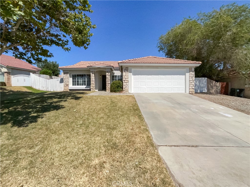 Welcome to this beautifully maintained property that boasts a host of desirable features. The home offers a covered patio, perfect for outdoor relaxation, and a fenced-in backyard for added privacy. The kitchen is a chef's dream with all stainless steel. The primary bedroom features a spacious walk-in closet, while the primary bathroom is equipped with double sinks for convenience. The neutral color paint scheme and fresh interior paint provide a clean, modern aesthetic. A cozy fireplace adds a touch of warmth and charm. This home is a must-see for anyone seeking a blend of comfort and style.. 100-Day Home Warranty coverage available at closing