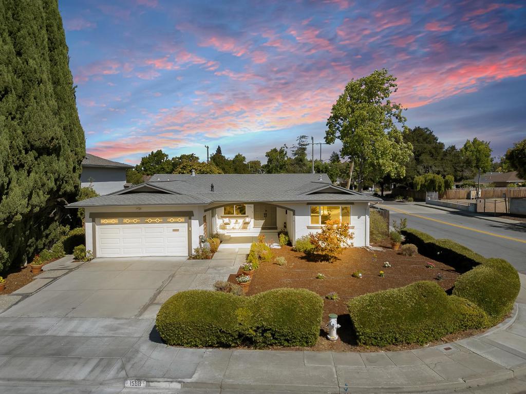 Modern single-story home on a landscaped corner lot just blocks from the new Apple campus! Freshly painted inside and out with new light fixtures throughout. Enjoy a spacious living room with a brick wood-burning fireplace, and sliding doors leading to the backyard. The bright dining room opens to both the kitchen and living room and features a stylish pendant light and yard access. The updated kitchen includes granite countertops, painted wood cabinetry, a farmhouse sink, and resilient flooring. A cozy family room offers additional living space with durable flooring and dimmer lights. The primary suite features a full wall of closets, fancy ceiling light, and sliding doors to the private backyard. Both bathrooms have been tastefully updated, new mirrors and lights. The fully fenced yard includes new landscaping in front and back, mature fruit trees, and an aggregate patioideal for outdoor entertaining. Minutes to Apple, Kaiser, Cupertino Square, and major commute routes with Sunnyvale schools!