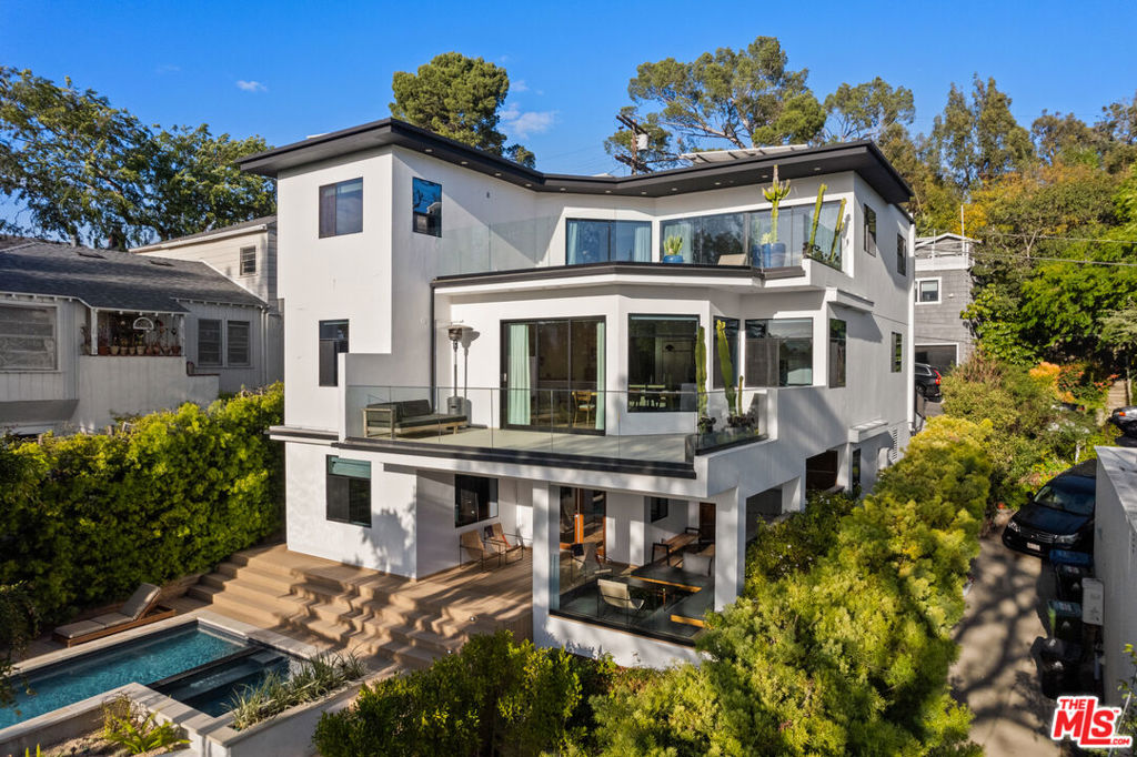 Welcome to 2457 Hidalgo Avenue, a modern and updated residence built in 2014 featuring 6 bedrooms and 5 bathrooms, with picturesque views of the Silver Lake Reservoir from all three levels. Inside, discover a bright and airy layout, where each room is bathed in natural light and showcases views of the reservoir and surrounding hills. The generous primary suite serves as a tranquil escape, featuring a lavish en-suite bathroom and abundant closet space. The kitchen, equipped with top-of-the-line appliances is perfect for hosting dinner parties or casual family meals. The home also includes a private guest unit on the lower level, ideal for visitors or as a home office in addition to a recording studio.