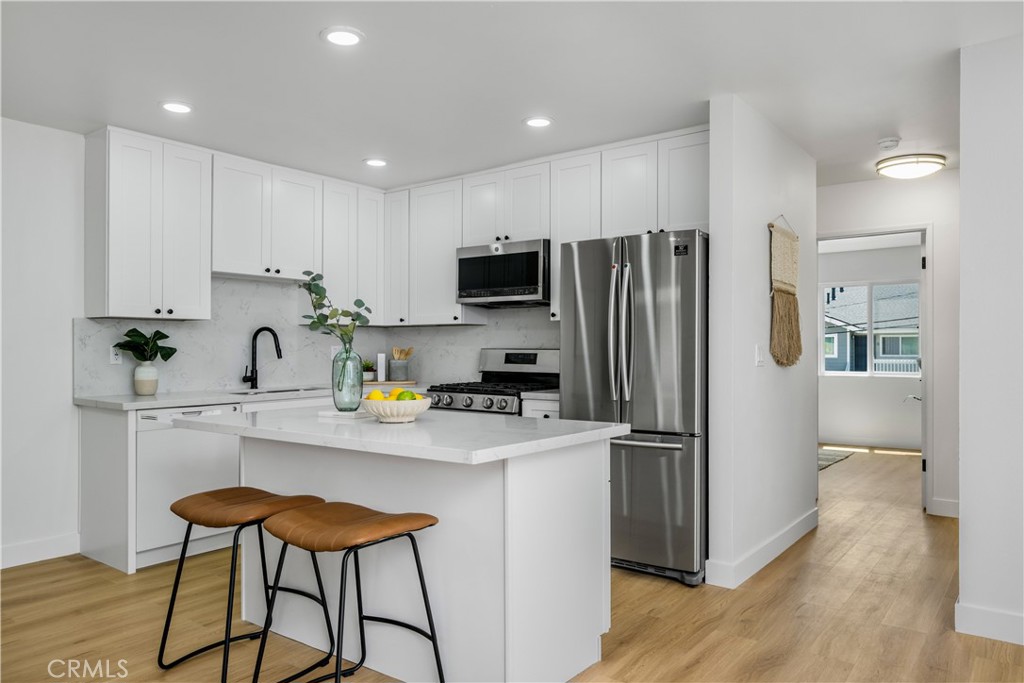 Welcome to this fully and stylishly remodeled 2-bedroom, 2-bath condo in the heart of Tustin. This bright second-floor, single-level condo features an open floor plan with a completely reimagined kitchen, including new cabinets, quartz countertops, an upgraded island with bar seating, and stainless steel appliances. Luxury vinyl plank flooring, recessed lighting, and fresh custom paint flow throughout the space. The primary suite offers a modern en-suite bathroom and a spacious walk-in closet, while the second bedroom is generously sized with a closet. Both bathrooms have been fully renovated with new vanities, a tub and a shower, each showcasing gorgeous soft palette tiles, along with new fixtures and plumbing. Additional upgrades include new double-pane windows, a brand-new HVAC system and an in-unit washer and dryer for added convenience. Enjoy three parking spaces, a shared garage with shelving, an assigned spot, and an unassigned space with a parking pass. The Williamshire community provides resort-style amenities including a pool, spa, clubhouse, and gym. Located within the award-winning Tustin Unified School District one of the best in the nation. This home combines style, comfort, and top-tier education. Centrally located near South Coast Plaza, Old Town Tustin, Irvine Spectrum Center, Laguna Beach, and Newport Beach, with easy access to freeways, dining, and attractions like Disneyland resort.