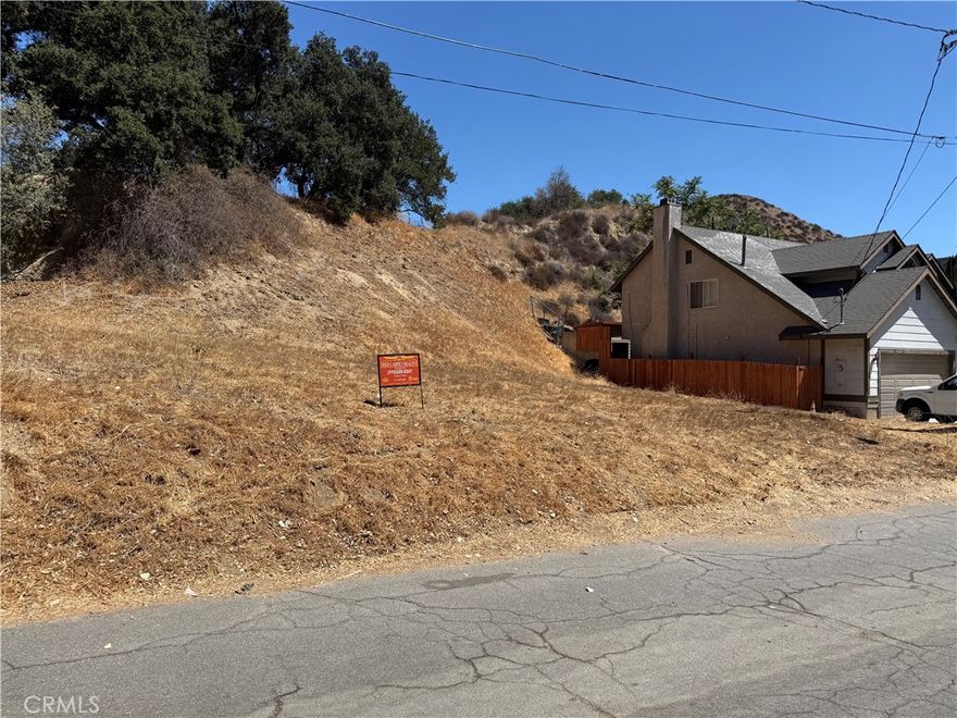 Seller financing available!   Affordable lot with utilities on paved street in established neighborhood!   Located in a charming area just a few minutes from Santa Clarita.  Electric and water are in the street.  Area uses septic for sewer.  Dimensions are approx 50' x 100'.  Don't miss out on this fantastic property at an excellent price!  Seller will finance with acceptable terms.  Buyer to verify all.