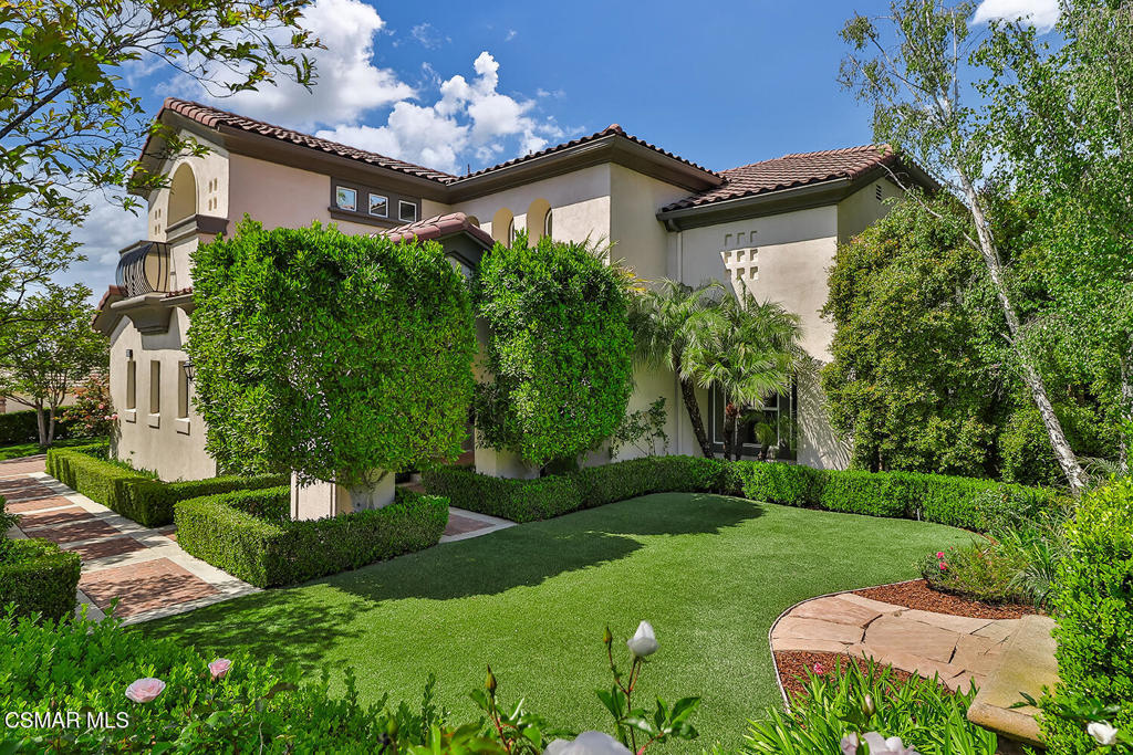 Best value for the money in Westlake Village!Elegant North Pointe Estate with DOUBLE IMPERIAL Staircases, Expansive Entertainer's Backyard & Incredible Privacy!Welcome to 2589 Featherwood Street--a STUNNING estate in the exclusive gated enclave of North Pointe, Westlake Village! Set on a beautifully manicured CORNER lot, this 5-bedroom + Bonus Room, 4.5-bath home offers 4,481 square feet of sophisticated living with TALL ceilings, bold architectural details, and a seamless flow designed for luxury, comfort, and entertainment.From the curb, the home's commanding presence is unmistakable: a striking paver-stone driveway, manicured landscaping, and a handsome stone-surfaced coffee nook create a grand welcome. Step inside through the elegant front door, flanked by sidelights and beneath triple arched windows, into a MAJESTIC foyer adorned by SOARING ceilings and regal DOUBLE IMPERIAL staircases with custom wrought-iron railings--a true showstopper.Formal spaces elevate entertaining, with a GRAND Dining Room showcasing a large arched window, lofty ceilings, and chic chandelier, while the Living Room stuns with a tray ceiling crowned by a custom mural. The Family Room is warm and inviting, boasting a built-in media center, gas fireplace, and a wall of tall plantation-shuttered windows framing views of the entertainer's backyard.At the heart of the home, the GOURMET Kitchen delivers everything a chef dreams of--highlighting an expansive central island, attractive granite countertops, custom cabinetry, sunny breakfast nook, and premium stainless-steel appliances including a GE Monogram 6-burner GAS cooktop and GE DOUBLE oven.The Primary Bedroom Suite enjoys its own private wing upstairs, accessed through double doors and offering sweeping VIEWS of the local hills/mountains from three tall windows, a double tray ceiling, and a DEEP walk-in closet with custom built-ins. The LAVISH Primary Bathroom indulges with stone-tile flooring, dual vanities, a jetted soaking tub, and a large tiled shower.Four additional bedrooms provide versatile living options: a downstairs bedroom with en-suite bath, two upstairs secondary bedrooms (one with an en-suite, one with access to the upstairs hall bath), plus a bright downstairs office with its own walk-in closet and plantation-shuttered windows overlooking the yard. A MASSIVE upstairs Bonus Room adapts beautifully as a media room, gym, or playroom, complete with deep walk-in storage and multiple closets.The entertainer's BACKYARD is a private oasis, framed by tall block walls and designed for unforgettable gatherings. Enjoy a spacious stamped colored-concrete patio under a NEW patio cover, a BUILT-IN BBQ center with stacked-stone surfacing, granite counters, stainless Fire Magic grill, and bar seating. A HALF-BASKETBALL COURT, sprawling artificial turf lawns, elegant hardscaping, concrete pathways, and a rotunda-style backyard lounge add layers of functionality and fun. A dedicated dog run area with artificial grass completes this versatile outdoor haven.Additional highlights include a 2-car garage with built-in metal cabinetry, ceiling storage racks & tool bench, plus a single-car garage currently outfitted as a home gym.At this home you'll enjoy CLOSE proximity to golf courses, parks, fantastic dining & shopping, with quick freeway access (101 & 23) for easy commuting. Zoned for top-tier Conejo Valley Unified schools, and just moments from North Ranch, Westlake Village Town Center, and serene hiking trails--this estate represents the pinnacle of Westlake Village living.Don't miss the chance to make this stunning North Pointe retreat your forever home!